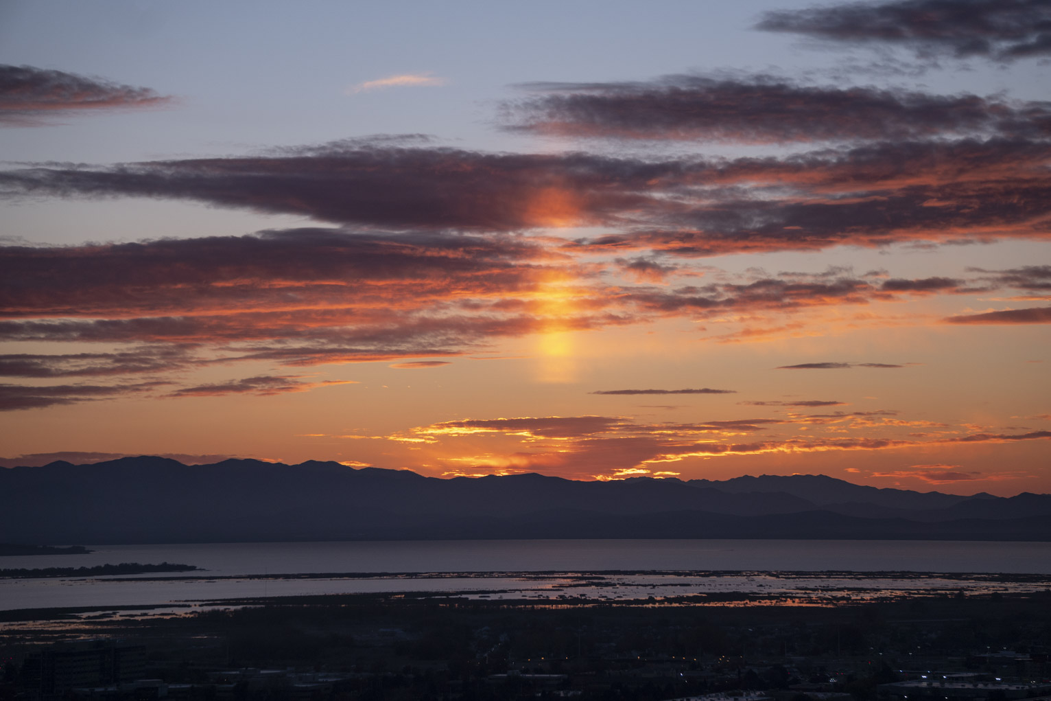 A bright sun pillar after sunset over Provo